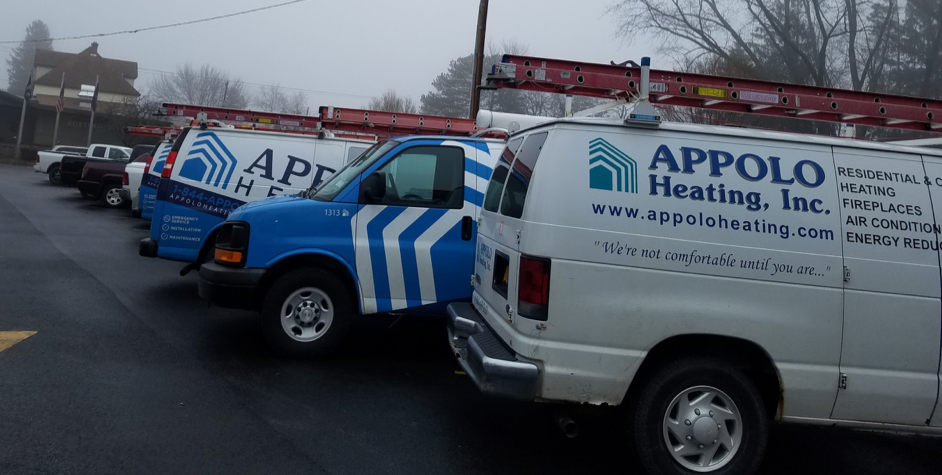 Appolo Heating Vans in a parking lot