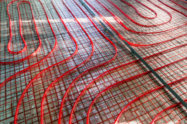 A floor heating system with red pipes and wires.