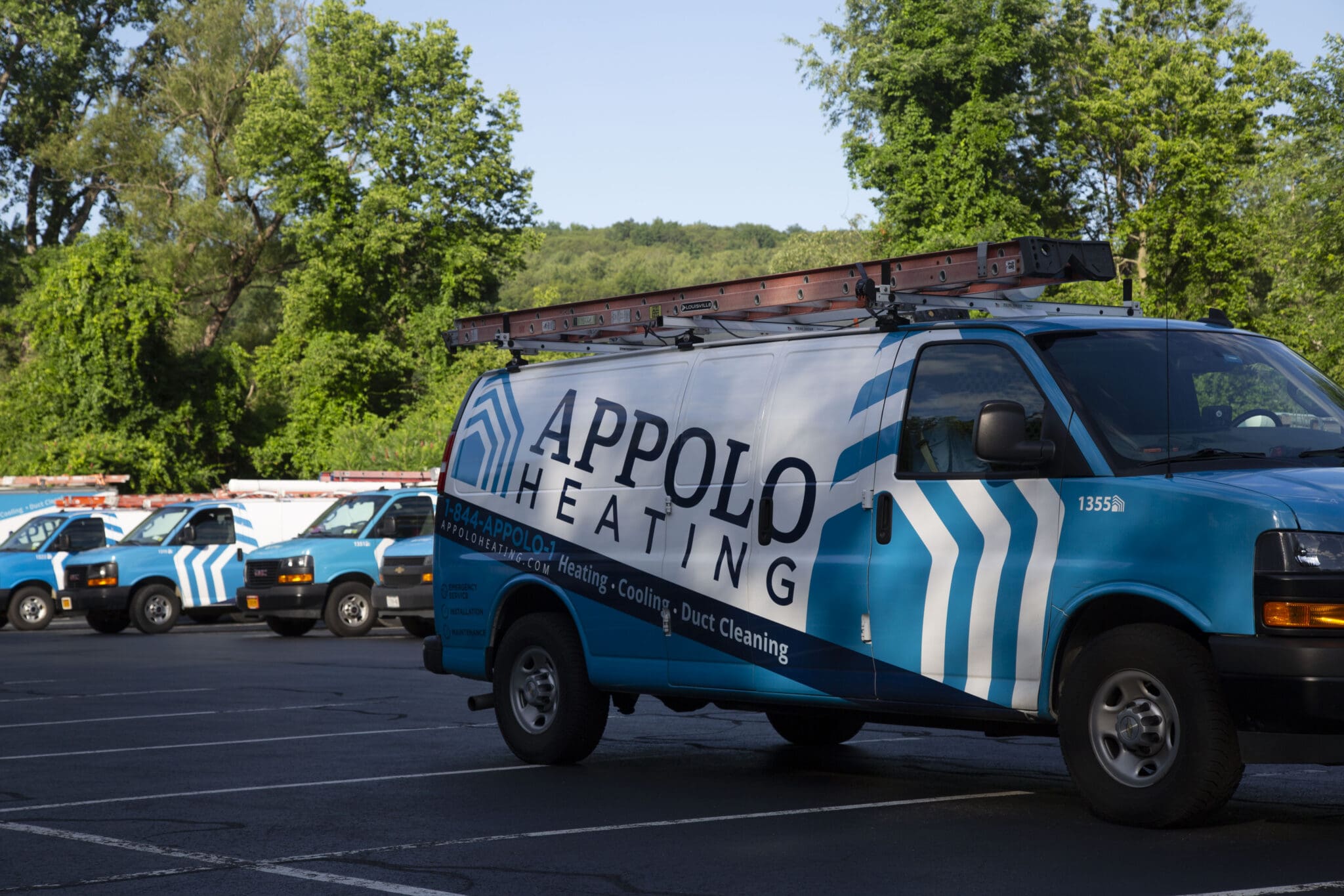 Blue van with "Appolo Heating" logo.